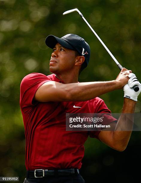 Tiger Woods watches a shot on the fifth hole during the final round of THE TOUR Championship presented by Coca-Cola, the final event of the PGA TOUR...