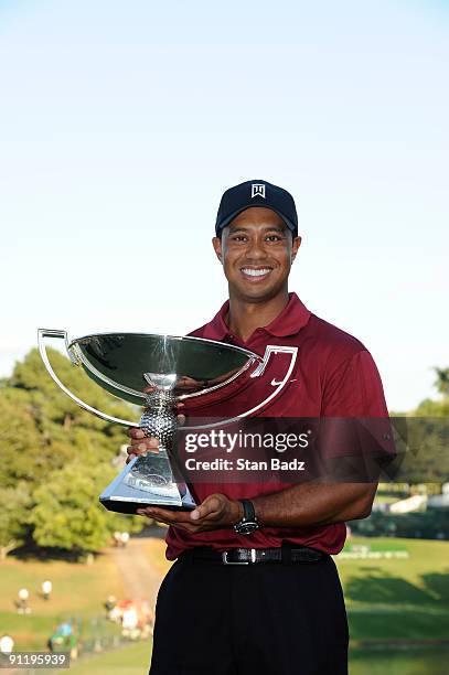 Tiger Woods holds the FedExCup Trophy after the final round of THE TOUR Championship presented by Coca-Cola, the final event of the PGA TOUR Playoffs...