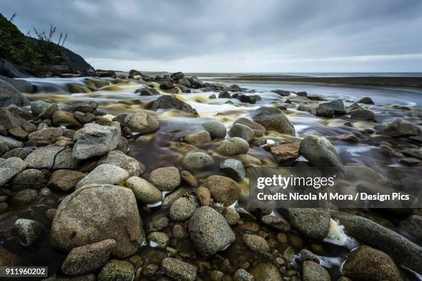 rocky karamea stream making its way to the sea - nickola beck stock pictures, royalty-free photos & images