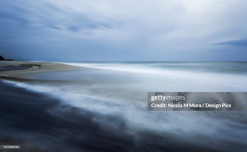 Stunning misty ocean water along the coastline as the tide comes in
