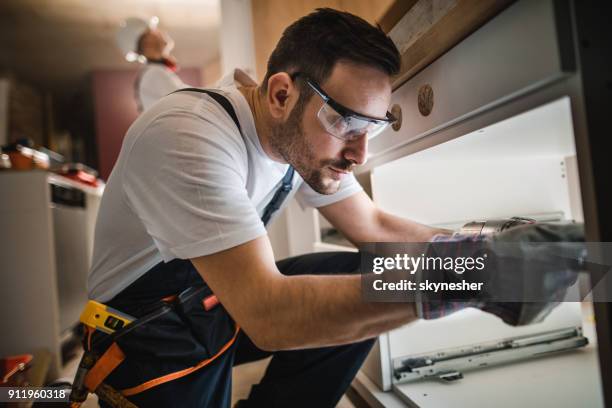manual worker drilling during home improvement process. - process improvement stock pictures, royalty-free photos & images