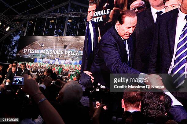 Italian Prime Minister Silvio Berlusconi greets his supporters after speaking at the Italian Party Of Freedom Festival on September 27, 2009 in...