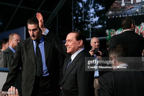 Italian Prime Minister Silvio Berlusconi greets his supporters after speaking at the Italian Party Of Freedom Festival on September 27, 2009 in...