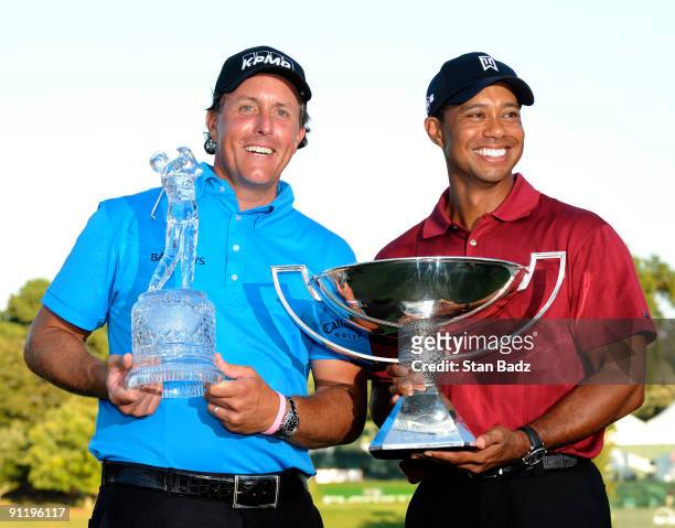 Phil Mickelson, left, wins THE TOUR Championship and Tiger Woods, right, wins the FedExCup after the final round of THE TOUR Championship presented...