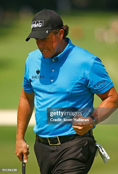 Phil Mickelson reacts after sinking a birdie putt on the fourth green during the final round of THE TOUR Championship presented by Coca-Cola, the...