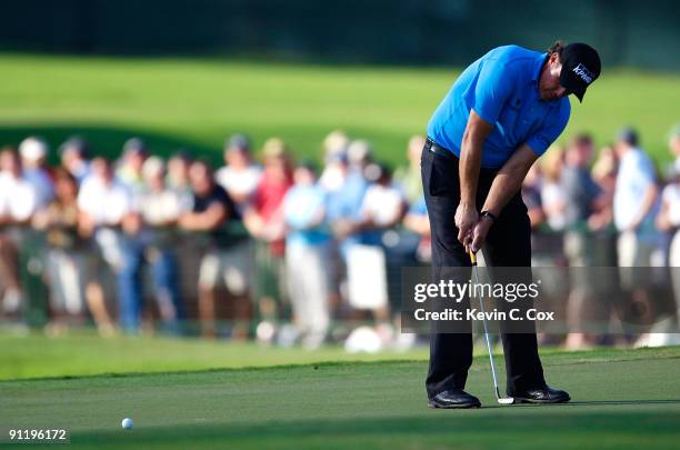 Phil Mickelson putts for birdie on the 17th green during the final round of THE TOUR Championship presented by Coca-Cola, the final event of the PGA...