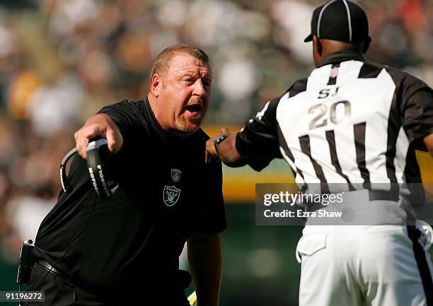 Oakland Raiders head coach Tom Cable argues with side judge Barry Anderson during their game against the Denver Broncos at the Oakland-Alameda County...