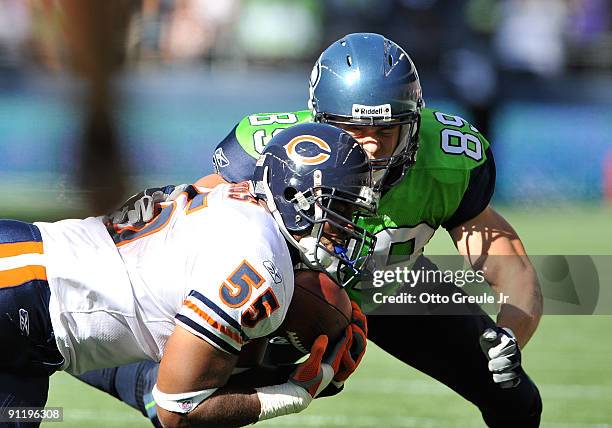 Linebacker Lance Briggs of the Chicago Bears makes an interception against John Carlson of the Seattle Seahawks on September 27, 2009 at Qwest Field...