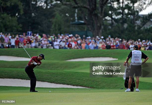 Tiger Woods hits to the 7th green during the final round of THE TOUR Championship presented by Coca-Cola, the final event of the PGA TOUR Playoffs...