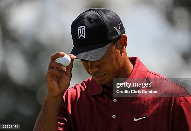 Tiger Woods acknowledges the gallery on during the final round of THE TOUR Championship presented by Coca-Cola, the final event of the PGA TOUR...