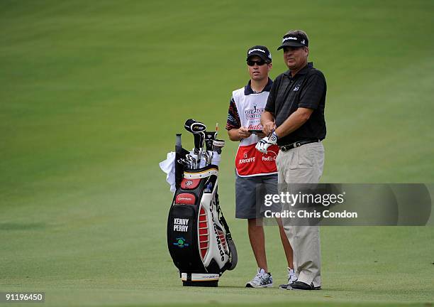 Kenny Perry and his Son Justin check yardage on the 4th fairway during the final round of THE TOUR Championship presented by Coca-Cola, the final...