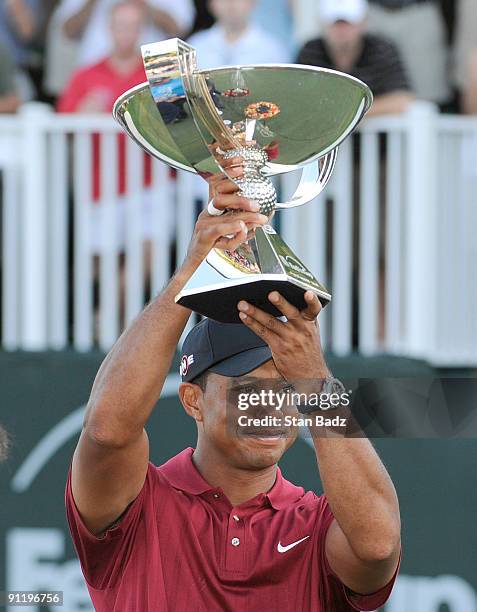 Tiger Woods hold the FedExCup Trophy after the final round of THE TOUR Championship presented by Coca-Cola, the final event of the PGA TOUR Playoffs...