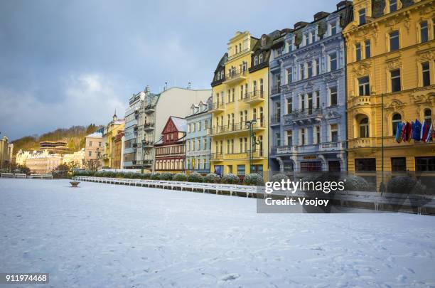colourful and elegent buildings on a snowy morning at karlovy vary, czech republic - karlovy vary stock pictures, royalty-free photos & images