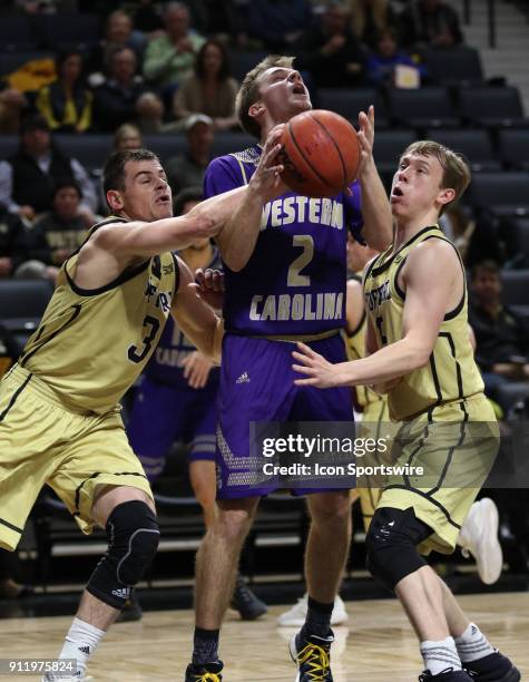 Matt Halvorsen guard Western Carolina University is fouled by Fletcher Magee guard Wofford College Terriers as he looks to shoot. Western Carolina...