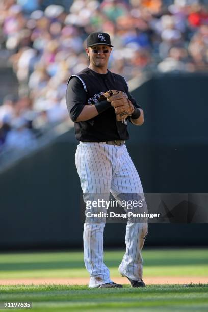 Troy Tulowitzki of the Colorado Rockies looks on during a break in the action as he plays defense against the St. Louis Cardinals at Coors Field on...