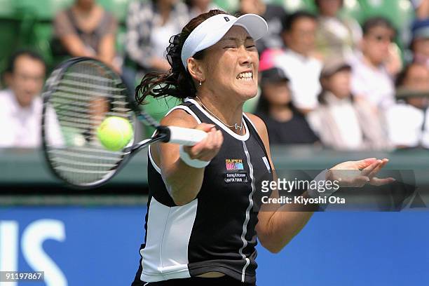 Ai Sugiyama of Japan plays a forehand in first round match against Nadia Petrova of Russia on day two of the Toray Pan Pacific Open Tennis tournament...