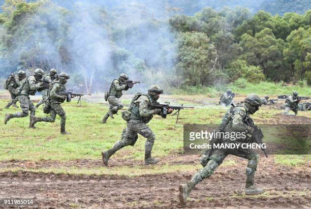 Soldiers stage an attack during an annual drill at the a military base in the eastern city of Hualien on January 30, 2018. Taiwanese troops staged...
