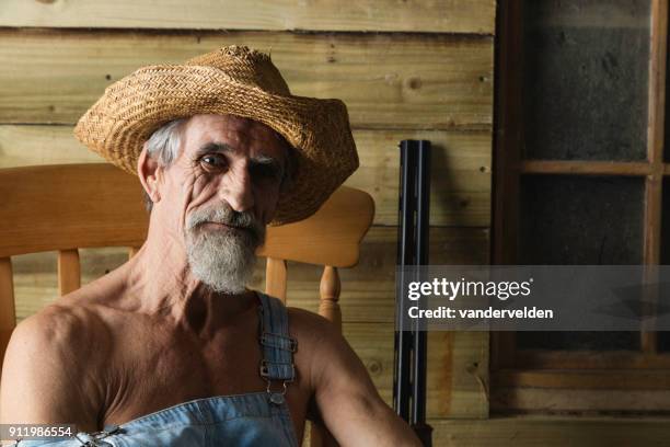 hick in bib overalls and straw hat - hillbilly stock pictures, royalty-free photos & images