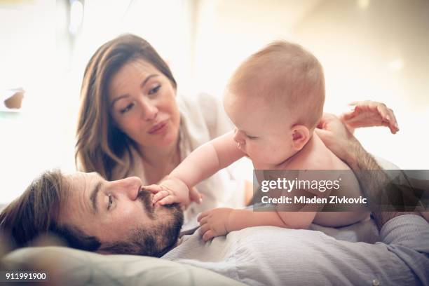 fun with baby boy. - dad holding baby up and lying down stock pictures, royalty-free photos & images