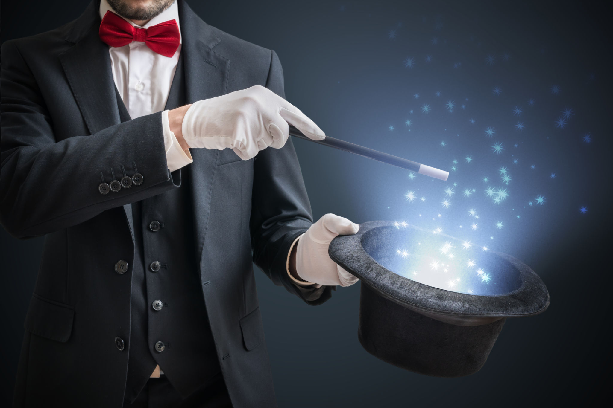 Magician or illusionist is showing magic trick. Blue stage light in background. Magician or illusionist is showing magic trick. Blue stage light in background.