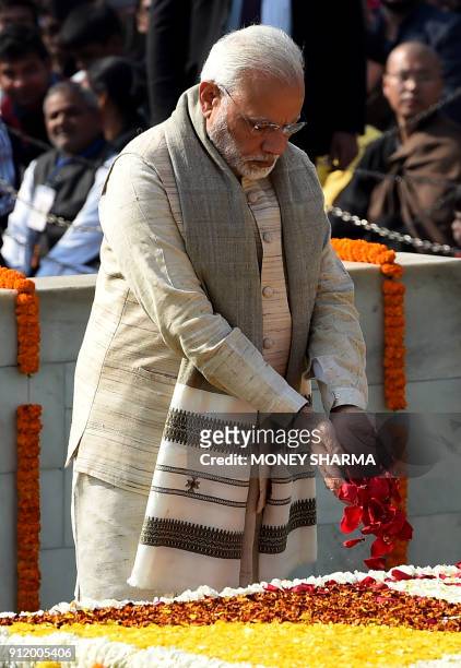 Indian Prime Minister Narendra Modi pays homage at Rajghat, the memorial for Indian independence icon Mahatama Gandhi, on Martyr's Day to mark the...