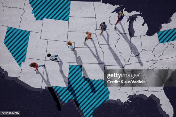 top view of group of people, walking across united states map, painted on asphalt - africa immigration stockfoto's en -beelden