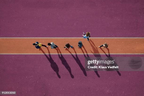 people walking in line on lane, painted on asphalt, one person walking off. - initiative photos et images de collection
