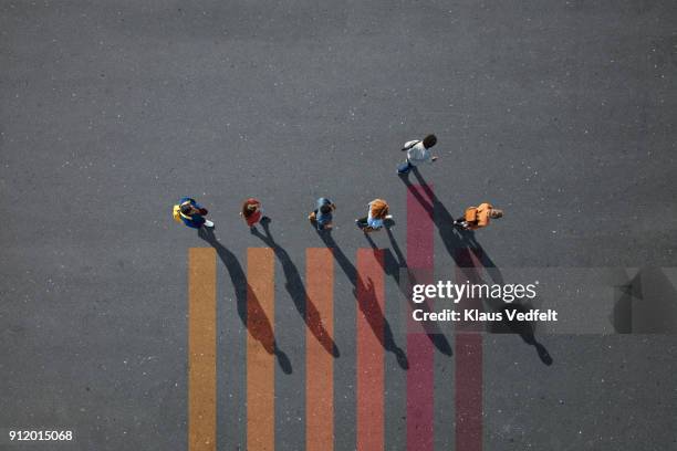people walking in line on bar chart painted on asphalt, one person walking off. - bar graph stock pictures, royalty-free photos & images