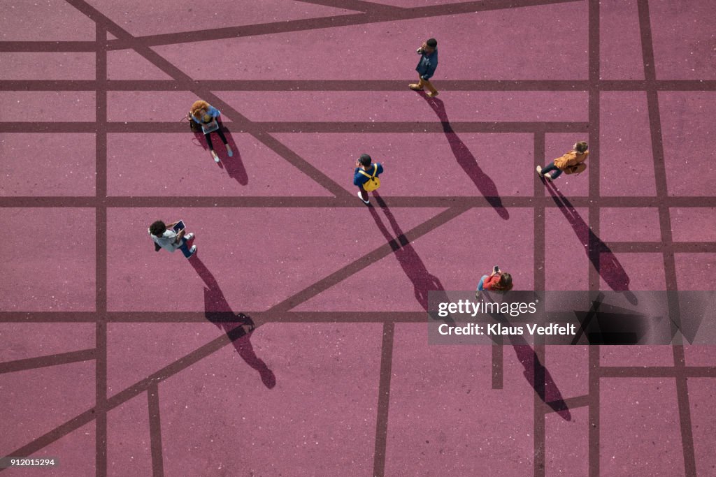 Group of people standing & sitting on roads, painted on asphalt