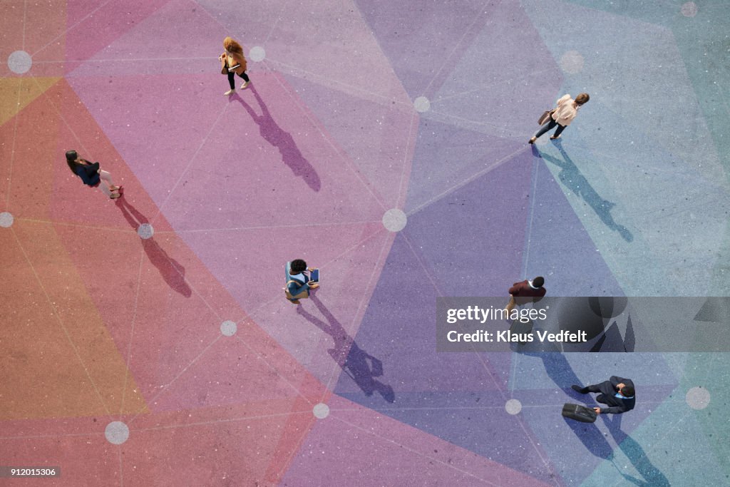 Top view of people walking in different directions of pattern, painted on asphalt