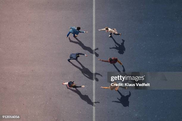 businesspeople stretching towards each other, on painted asphalt - dispute stock-fotos und bilder