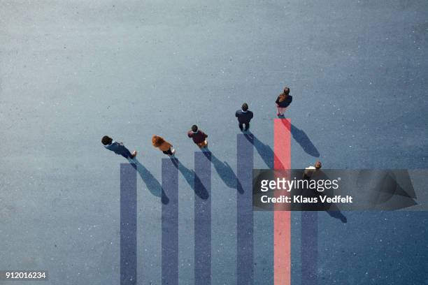 businesspeople standing on painted bar chart graph on asphalt - business performance photos et images de collection