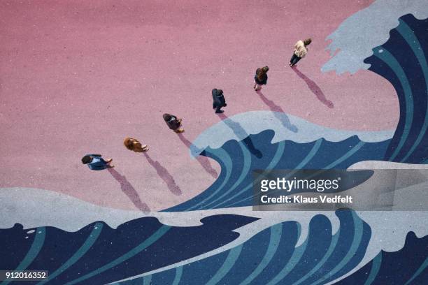 businesspeople standing in line with big panted waves on asphalt - crisi foto e immagini stock