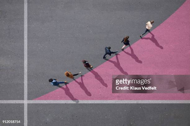 businesspeople walking on painted up going graph, on asphalt - gelegenheit stock-fotos und bilder