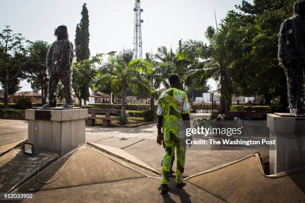 Man walks passed a statue of Félix Francisco de Souza, one of the biggest slave merchants in history and father of Ouidah, at a park where the former...