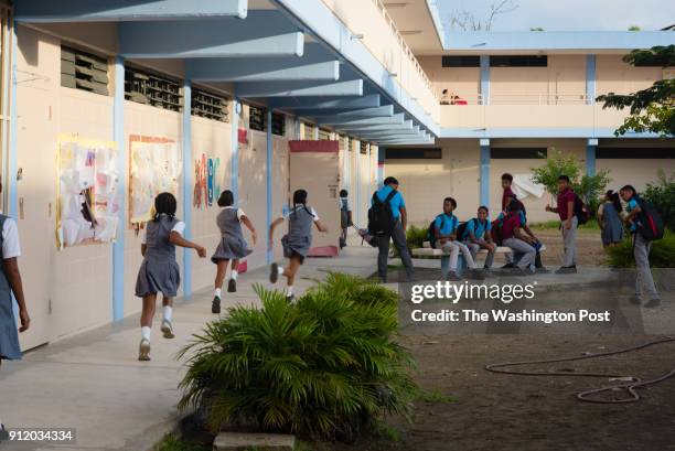 Children run before school at Medianía Alta Elemental in Loiza, Puerto Rico. Stranded residents of Loiza took shelter during and after the storm in...