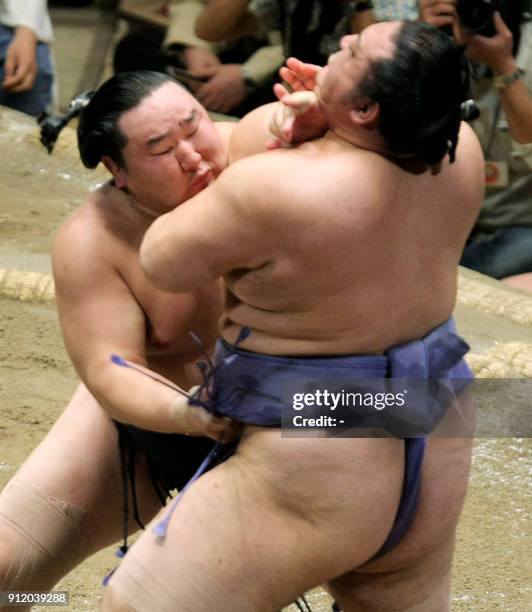 Mongolian sumo grand champion Asashoryu pushes veteran Japanese ranked wrestler Kaio out of the ring during the 12th day of the Autumn Grand Sumo...