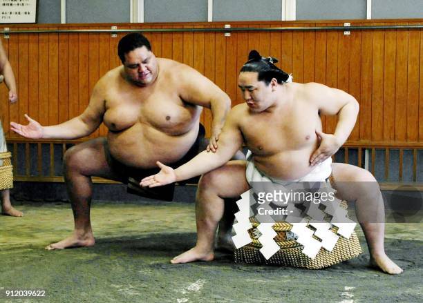 Newly promoted Mongol-born "Yokozuna," grand champion Asashoryu takes a lesson of "Dohyo-Iri," a ceremonial stumping from ex-Yokozuna Akebono from...