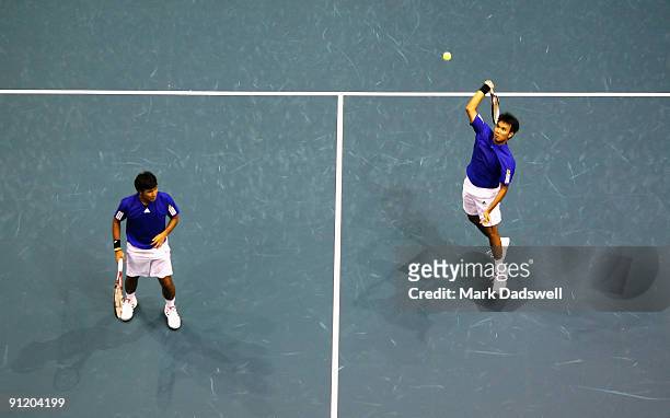 Sanchai Ratiwatana plays a forehand smash in his doubles match with Sonchat Ratiwatana against Benjamin Becker of Germany and Leonardo Mayer of...