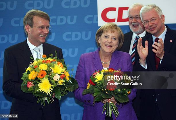 German Chancellor and Chairwoman of the Christian Democratic Union political party Angela Merkel smiles as she poses for a photo with CDU General...