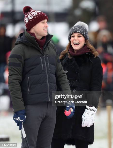 Prince William, Duke of Cambridge and Catherine, Duchess of Cambridge laugh as they attend a Bandy hockey match where they will learn more about the...