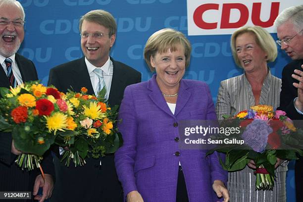 German Chancellor and Chairwoman of the Christian Democratic Union political party Angela Merkel smiles as she poses for a photo with CDU Governor of...