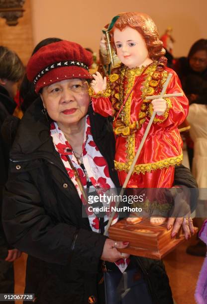 Filipino Catholics bring the statues of Santo Niño from their homes to the church to be blessed during the Feast of Santo Niño de Cebú in Toronto,...