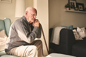 Elderly man sitting alone at home