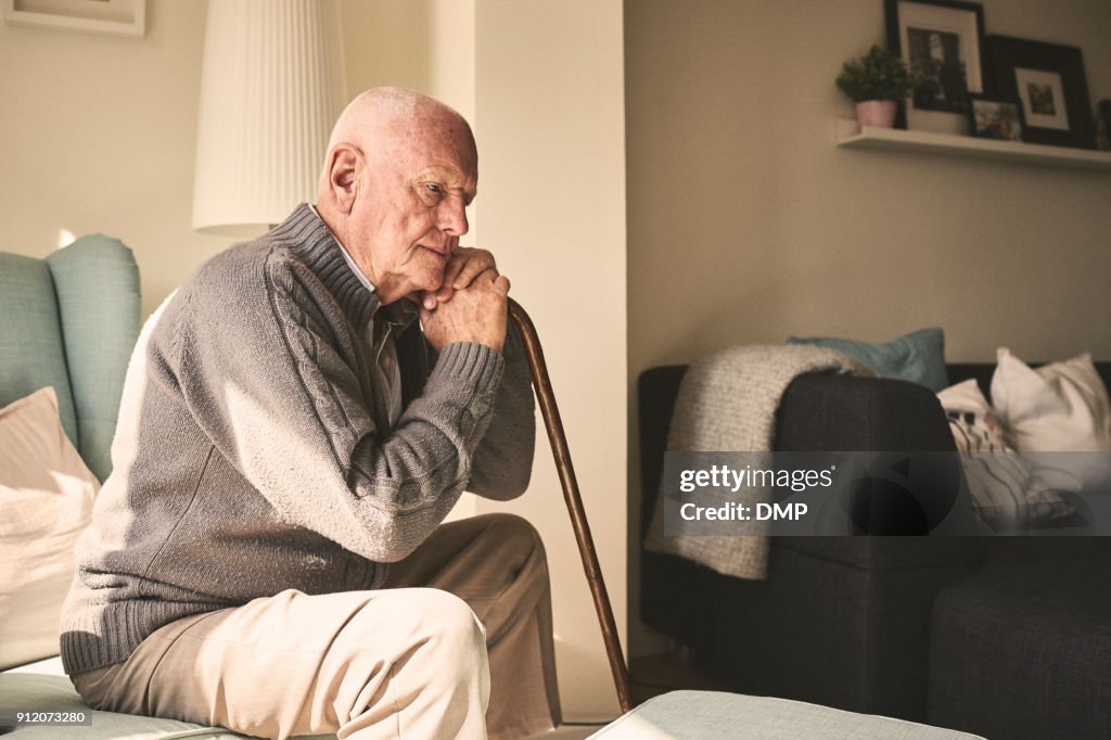Elderly man sitting alone at home