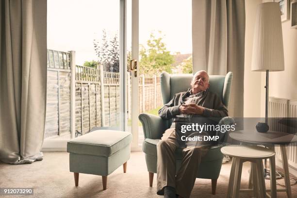 senior man sleeping on a armchair - armchair stock pictures, royalty-free photos & images