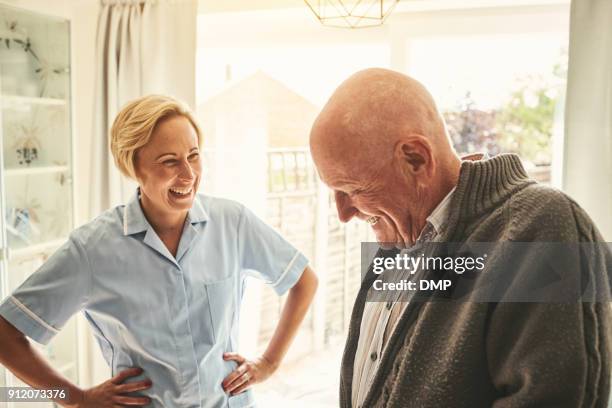 smiling senior man and female carer at home - old man laughing stock pictures, royalty-free photos & images