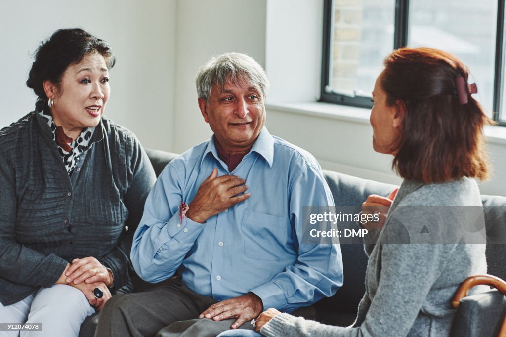 Female carer treating senior couple