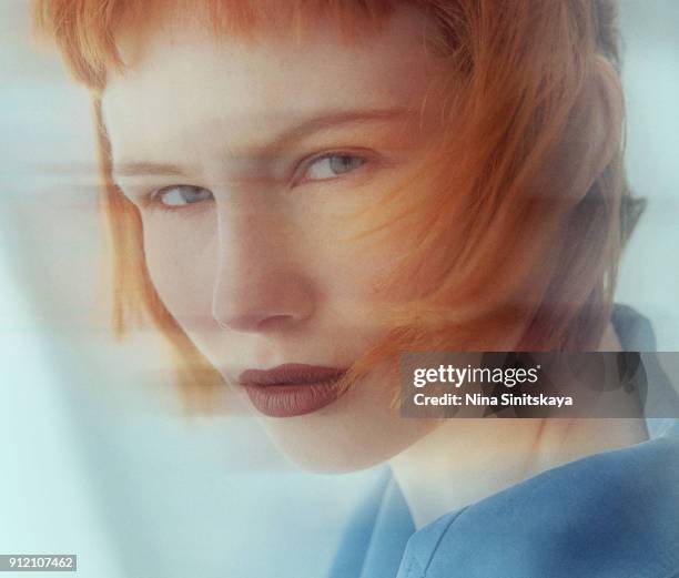 close-up of red woman with blue eyes, blurred motion - long exposure - double exposure portrait stock pictures, royalty-free photos & images