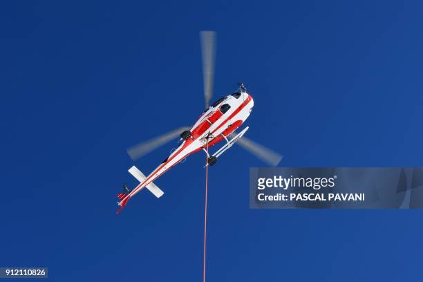 Helicopter is used during the installation of a 12-meter-long platform at the top of the Pic du Midi, one of France's tallest mountains, in...